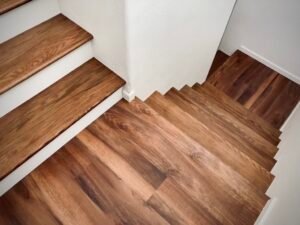 Photo of stairs wrapping around a wall with new vinyl plank flooring